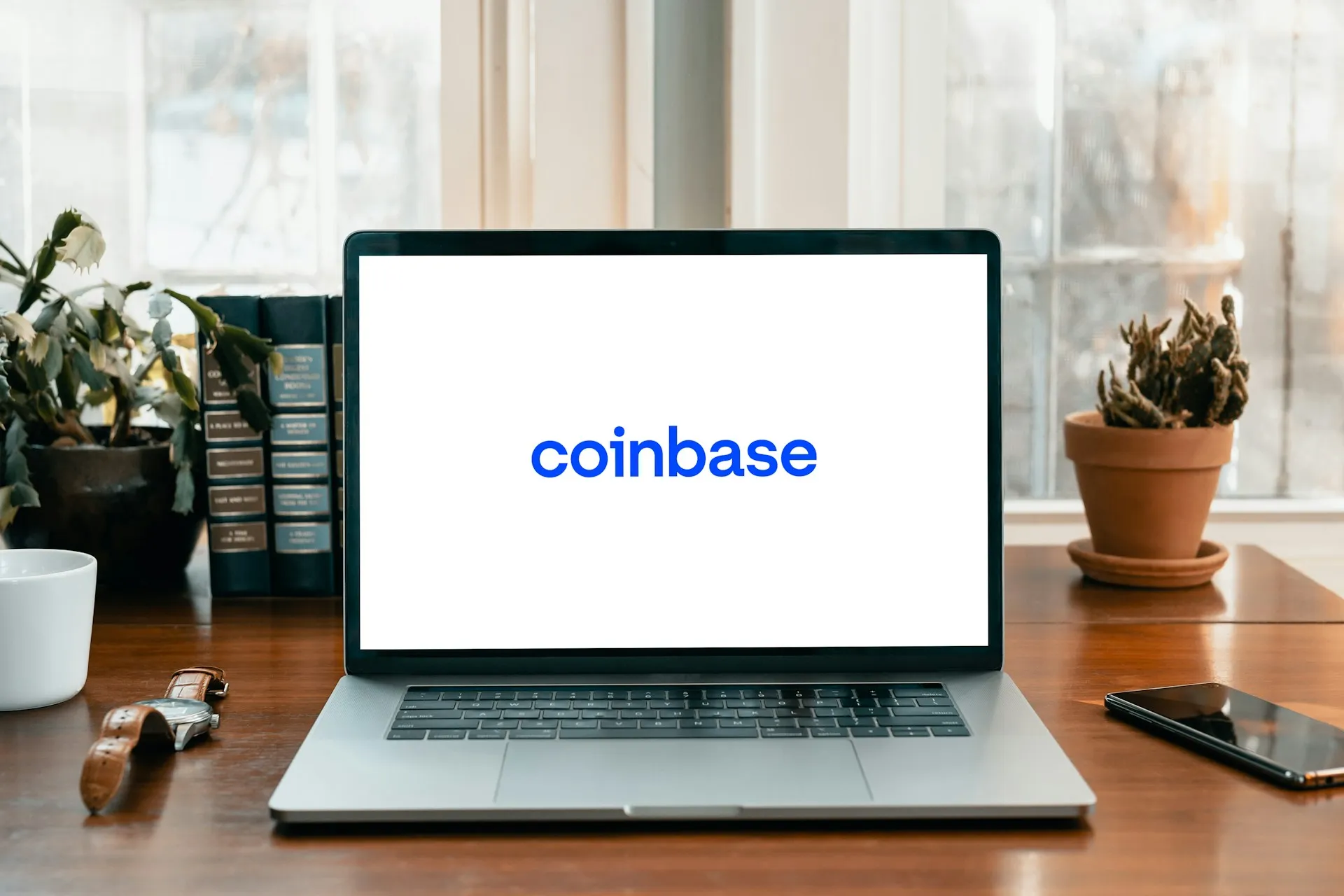 An image of a computer that is showing the logo of Coinbase.